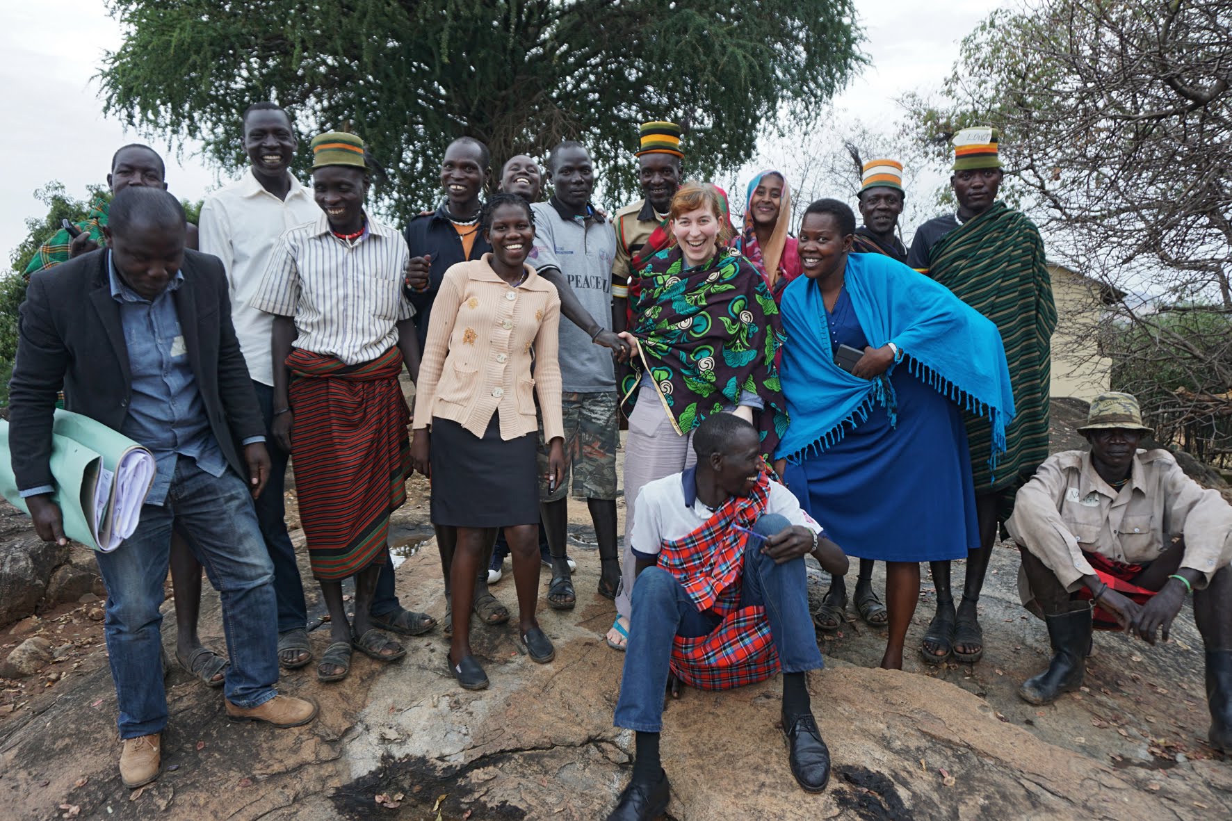 Group photo of members of the tribal group, trainees as well as Sabine, smiling into the camera.